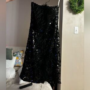 Black embellishments and ostrich fur dress